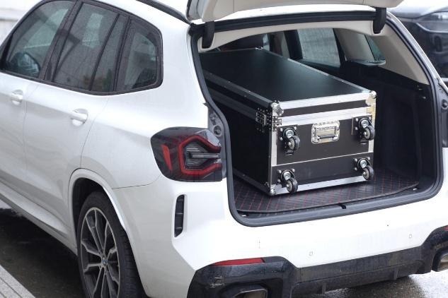 Packed booth case loaded in a car trunk